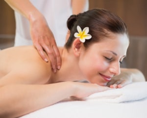 smiling woman enjoying shoulder massage