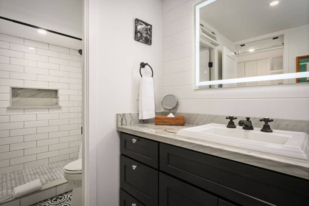 bathroom with a walk-in shower and a large mirror