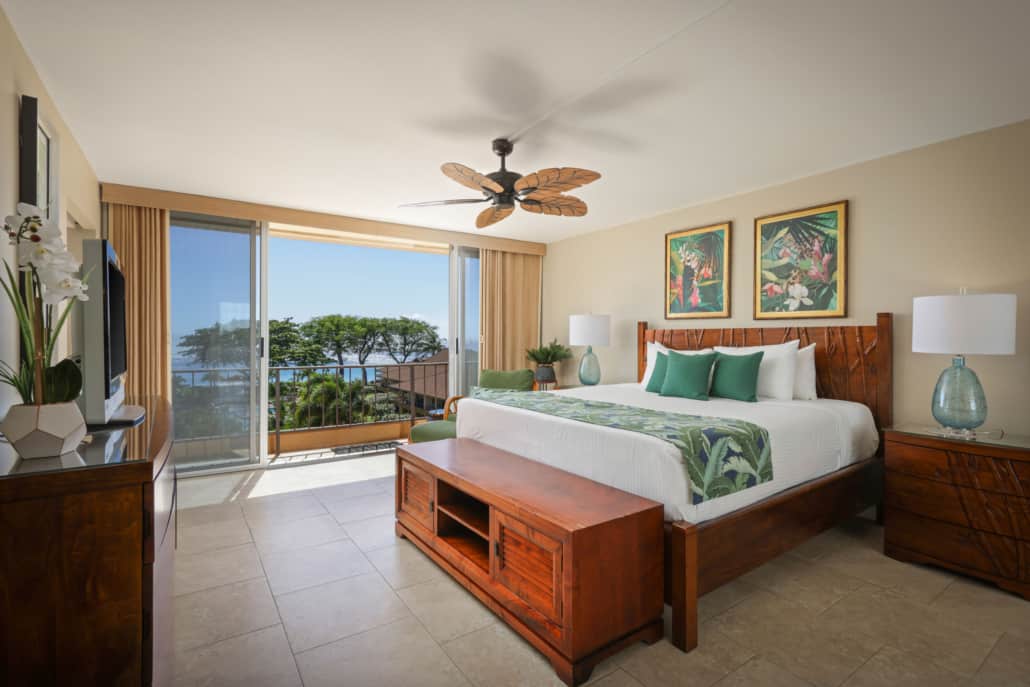 bedroom with a bed and two side tables with lamps and a lanai with a veiw