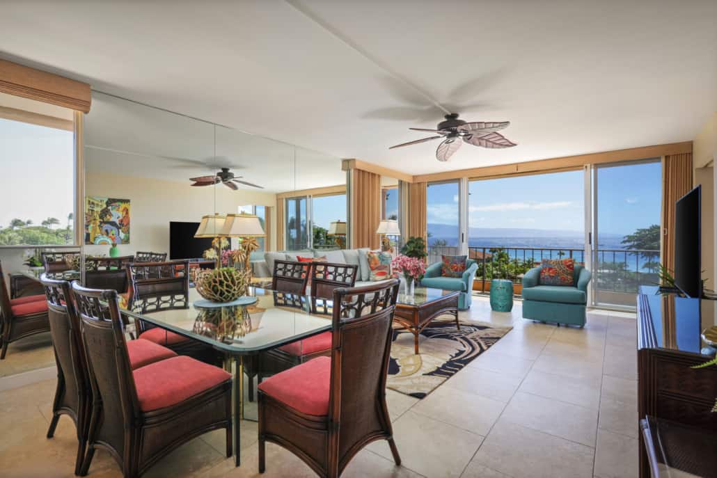 Living room space with a dining table and chairs, separate seating area and coffee table, television and a lanai with a view