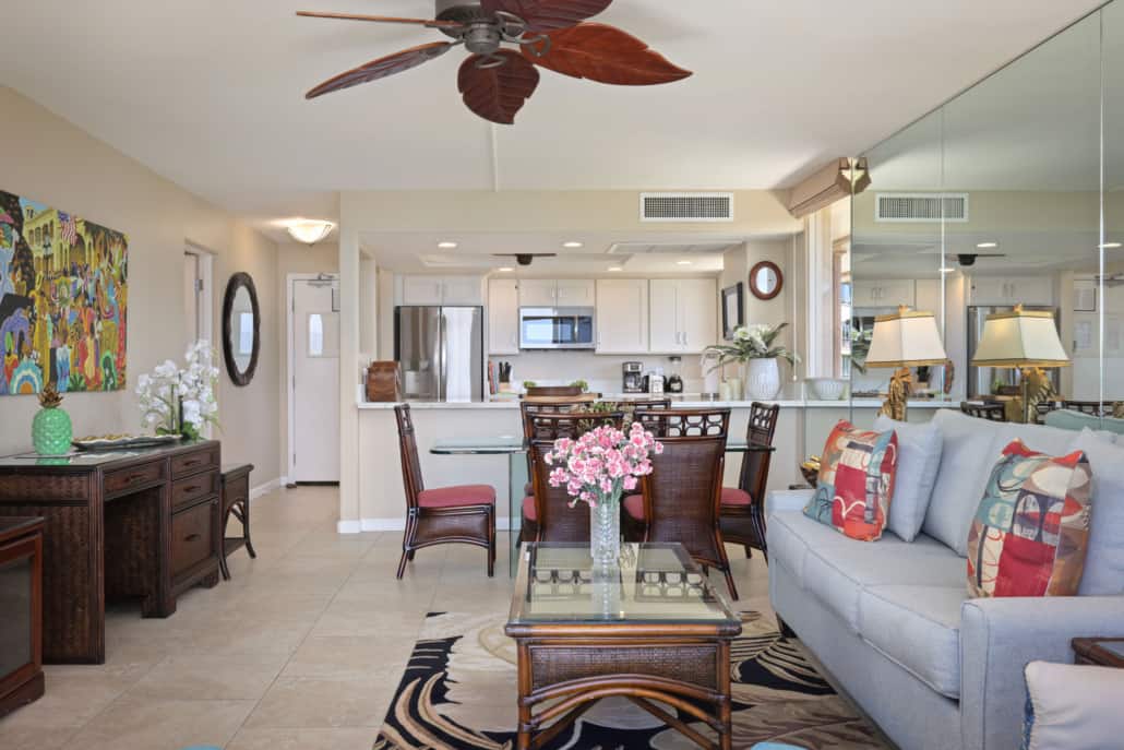 View of the unit looking in with full kitchen with refrigerator, microwave, a dining area, a separate seating area and a desk