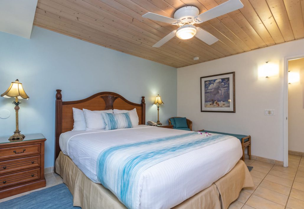 Condo with bedroom, end tables, lights, and seating area
